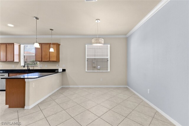 kitchen with light tile patterned flooring, crown molding, kitchen peninsula, and hanging light fixtures