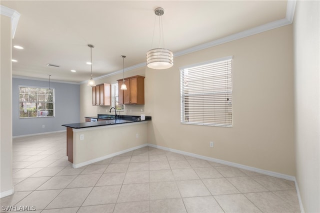 kitchen featuring light tile patterned floors, kitchen peninsula, hanging light fixtures, sink, and ornamental molding