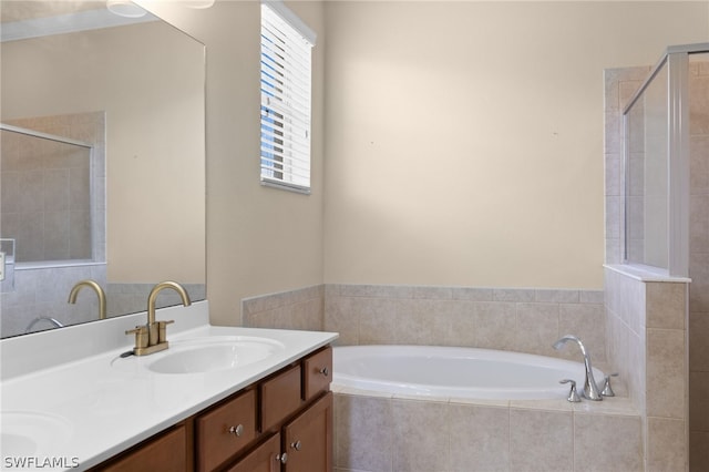 bathroom featuring double vanity and separate shower and tub