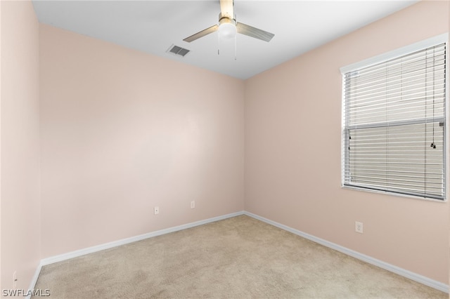 spare room with carpet and ceiling fan