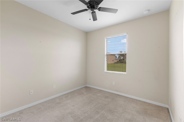 carpeted spare room with ceiling fan