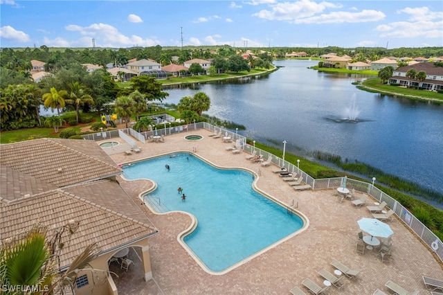 view of pool with a water view and a patio area