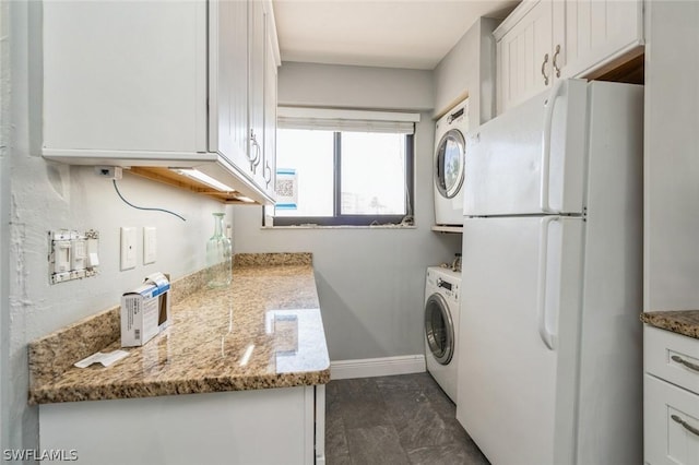 laundry room with stacked washing maching and dryer