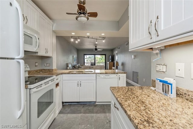 kitchen featuring white cabinetry, white appliances, and kitchen peninsula