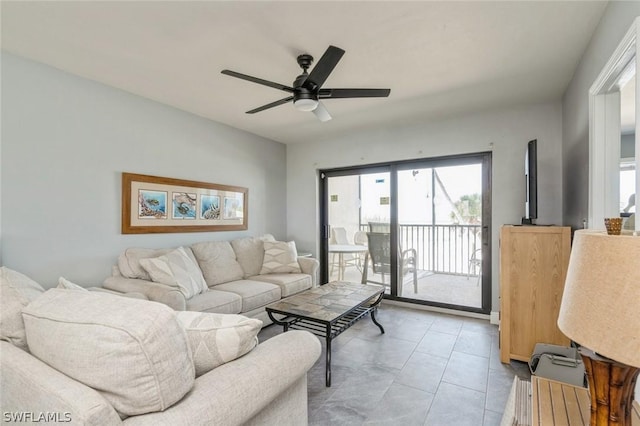 living room with ceiling fan and light tile patterned flooring