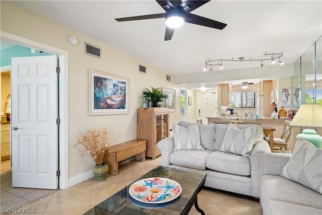 living room with ceiling fan and light tile patterned flooring