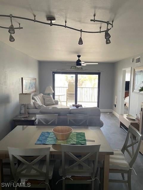 dining space featuring ceiling fan, track lighting, and a healthy amount of sunlight