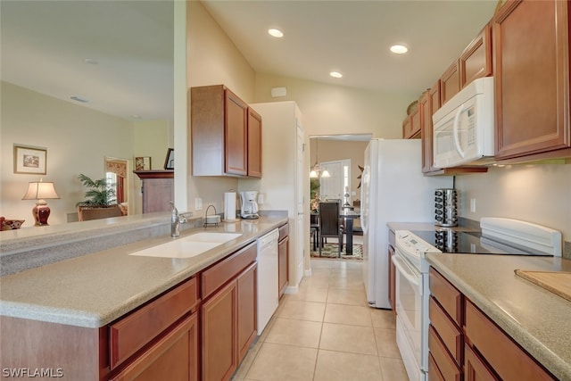 kitchen featuring sink, light tile patterned floors, and white appliances