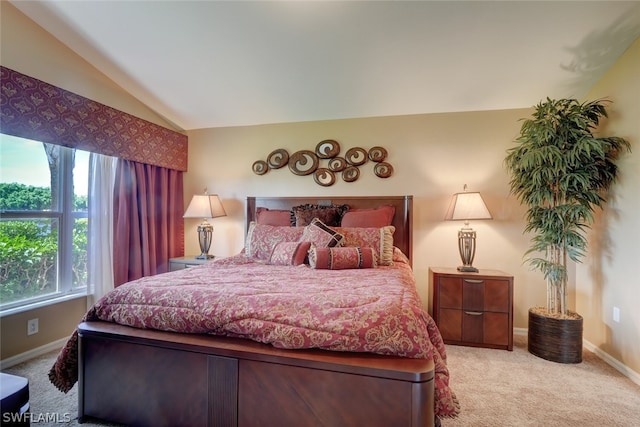 bedroom with light carpet and lofted ceiling