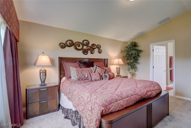 carpeted bedroom with lofted ceiling