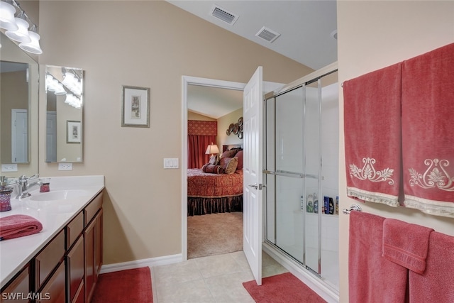 bathroom featuring vaulted ceiling, vanity, an enclosed shower, and tile patterned floors