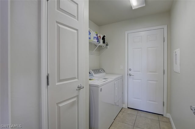 washroom featuring light tile patterned flooring and washer and clothes dryer