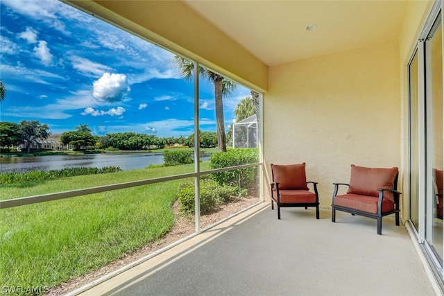 sunroom / solarium with a water view