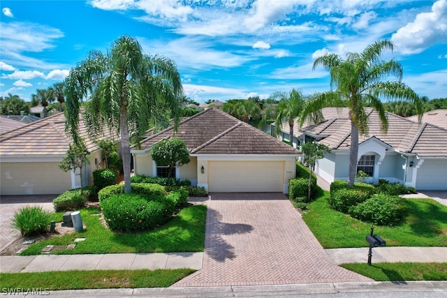 single story home featuring a garage and a front lawn