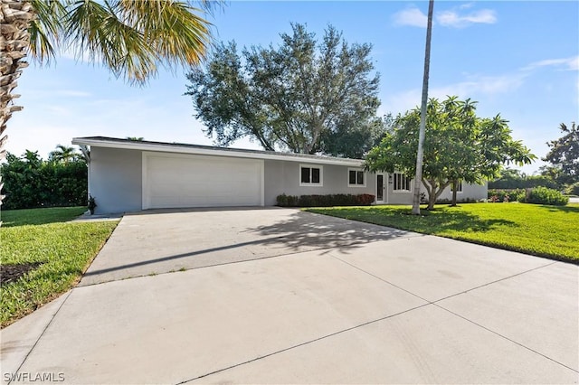 single story home featuring a garage and a front lawn