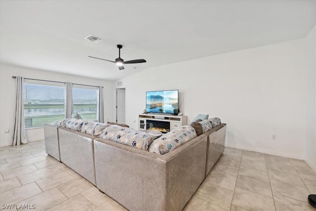 tiled living room with lofted ceiling and ceiling fan