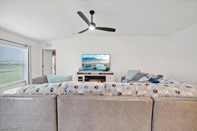 living room featuring vaulted ceiling and ceiling fan