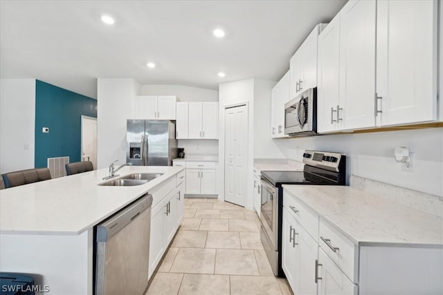 kitchen featuring sink, an island with sink, white cabinets, and appliances with stainless steel finishes