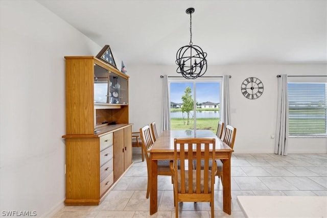 dining area featuring a notable chandelier and light tile patterned flooring