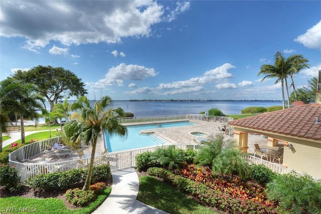 view of swimming pool featuring a community hot tub and a water view