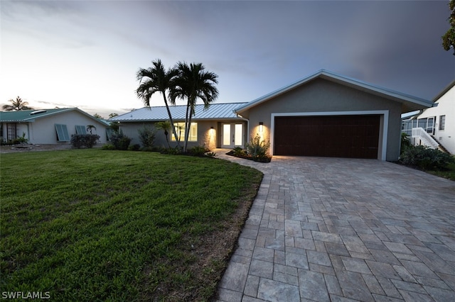 view of front of house featuring a lawn and a garage