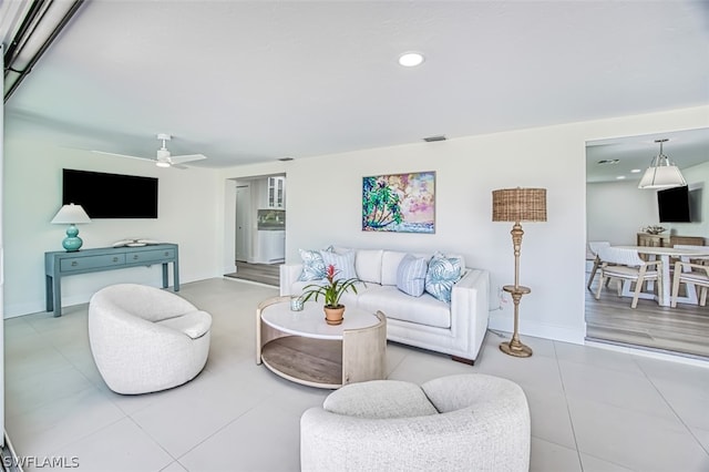 living room with tile patterned floors and ceiling fan