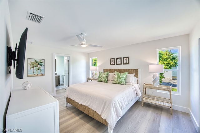 bedroom featuring ensuite bath, ceiling fan, and light hardwood / wood-style floors