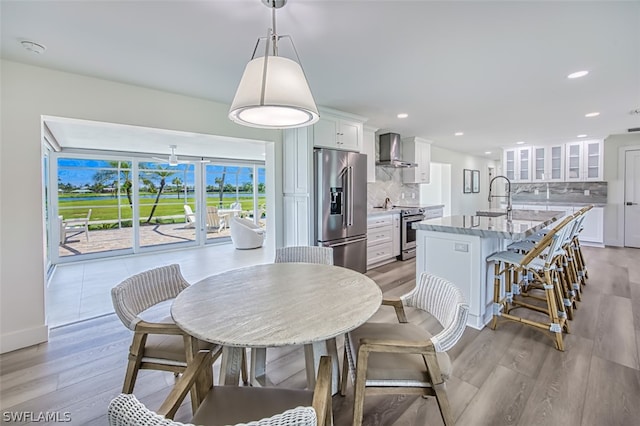 dining area with light hardwood / wood-style floors and sink