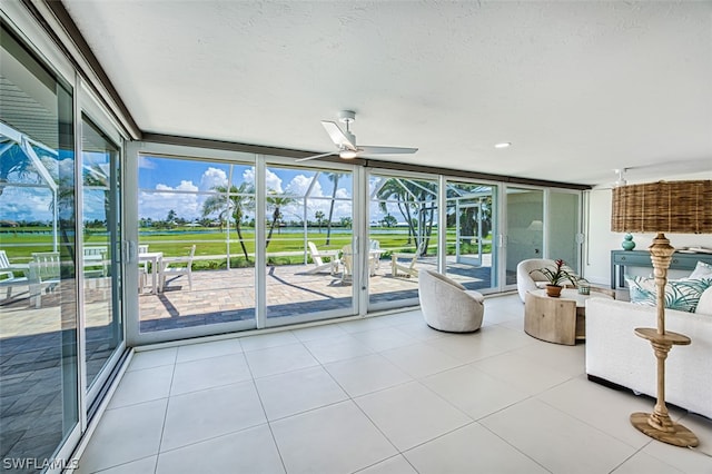 interior space featuring floor to ceiling windows, a wealth of natural light, and ceiling fan