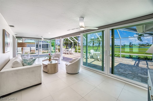 sunroom featuring ceiling fan and a wealth of natural light