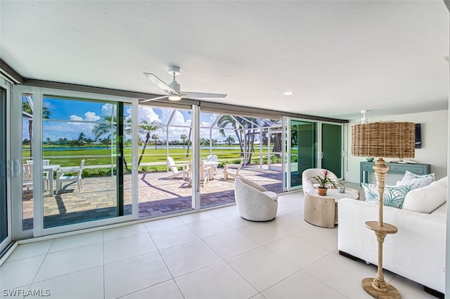 tiled living room featuring floor to ceiling windows and ceiling fan