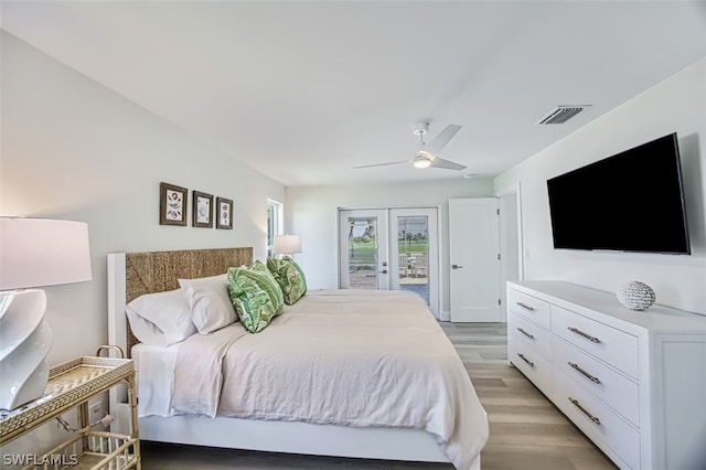 bedroom featuring access to exterior, french doors, light hardwood / wood-style floors, and ceiling fan