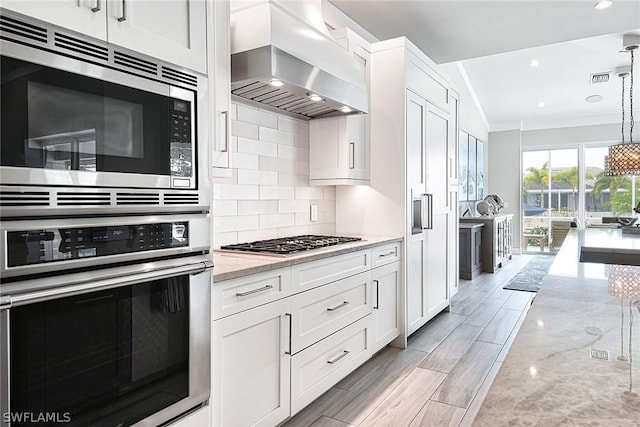 kitchen with stainless steel appliances, ventilation hood, and white cabinets