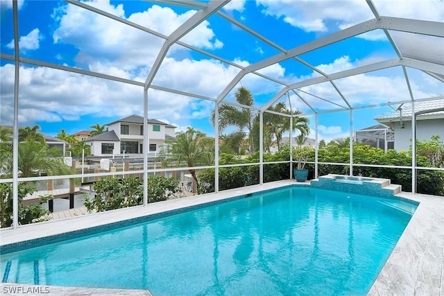 view of swimming pool with a lanai