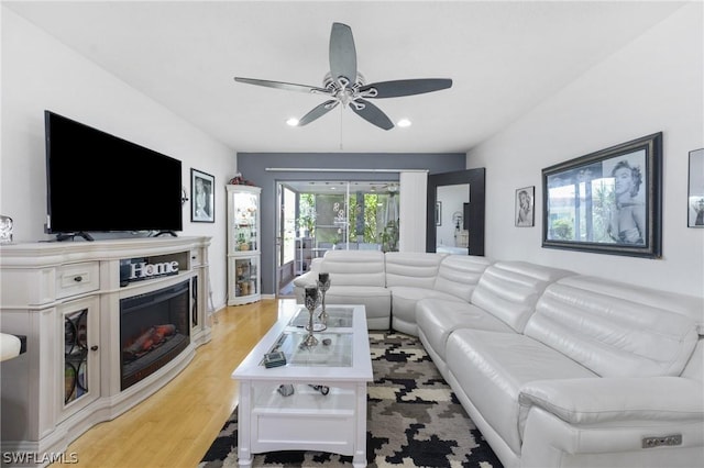 living room featuring ceiling fan and light hardwood / wood-style floors