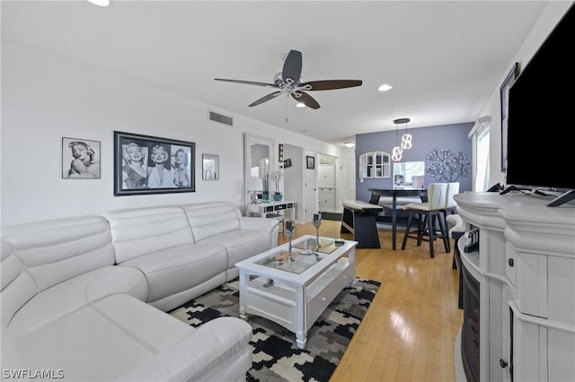 living room featuring hardwood / wood-style floors and ceiling fan