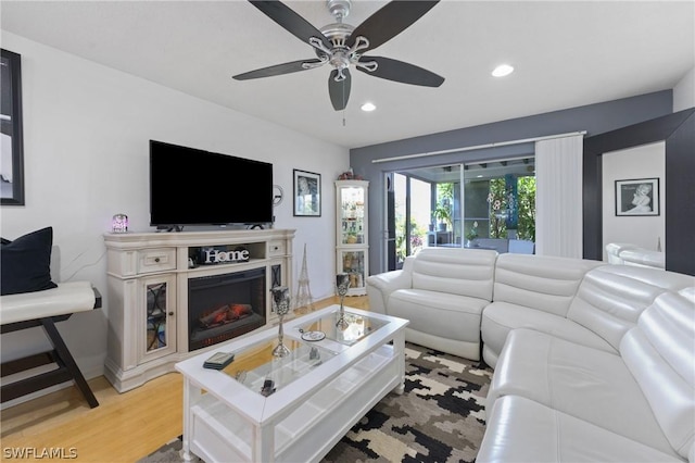 living room featuring light wood-type flooring and ceiling fan