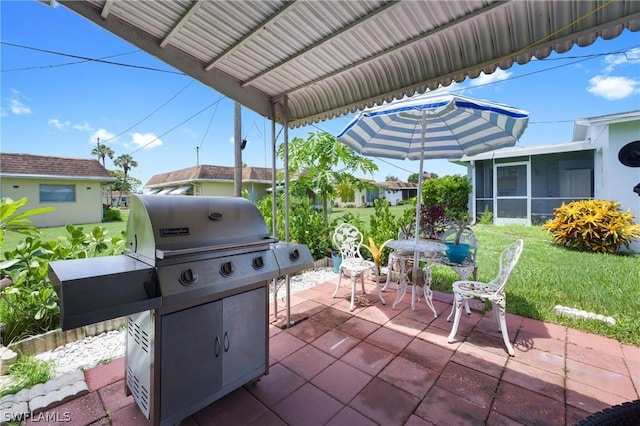 view of patio featuring grilling area and a sunroom