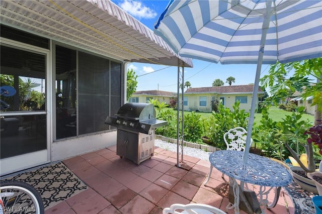 view of patio / terrace featuring area for grilling and a sunroom