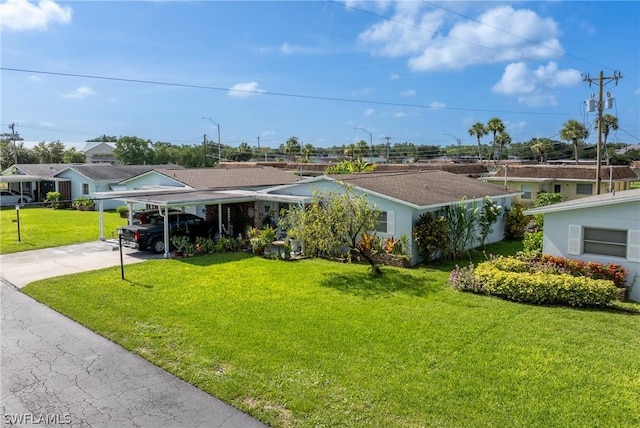 view of front of property with a front yard and a carport