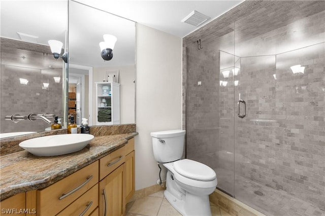 bathroom with vanity, toilet, an enclosed shower, and tile patterned flooring