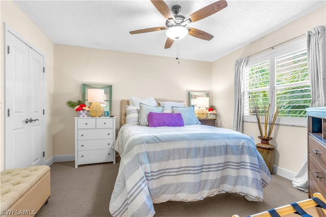 carpeted bedroom featuring a textured ceiling and ceiling fan