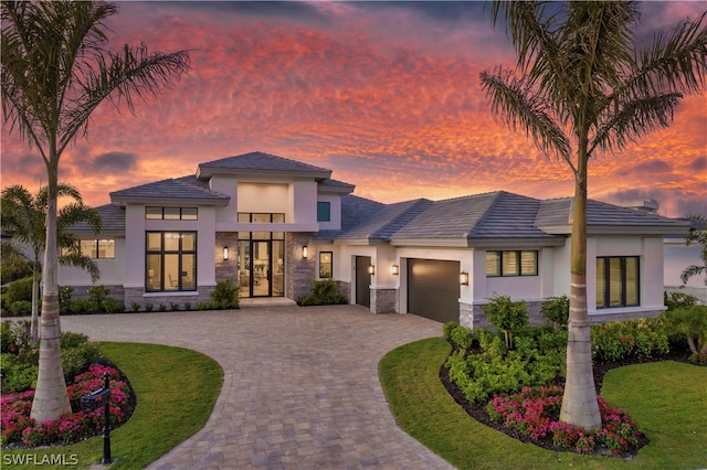 prairie-style home with a lawn and a garage