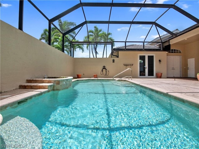 view of pool with a lanai, french doors, and a patio