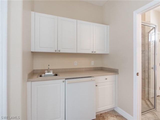 bar featuring dishwasher, sink, and white cabinetry