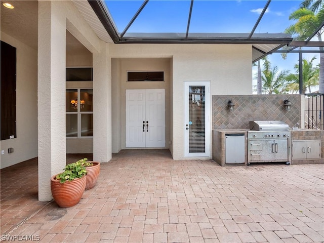 entrance to property featuring a patio area and area for grilling