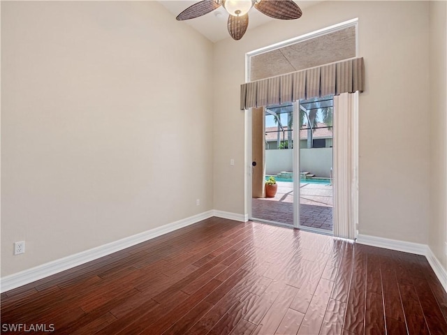 spare room with ceiling fan and dark hardwood / wood-style floors