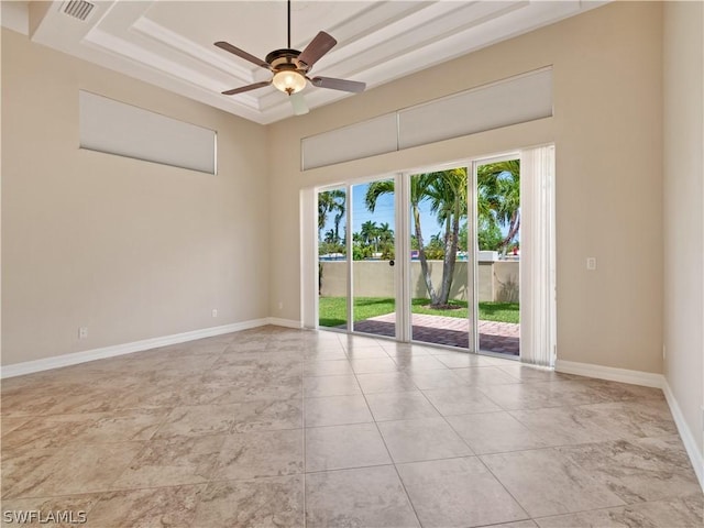 unfurnished room with a raised ceiling and ceiling fan