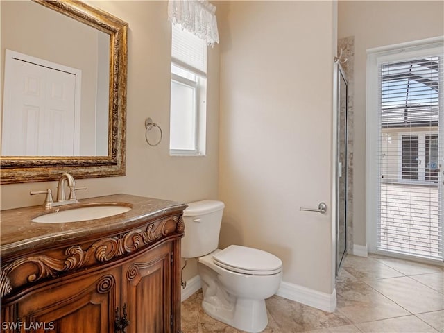 bathroom featuring tile patterned flooring, a healthy amount of sunlight, a shower with door, and vanity