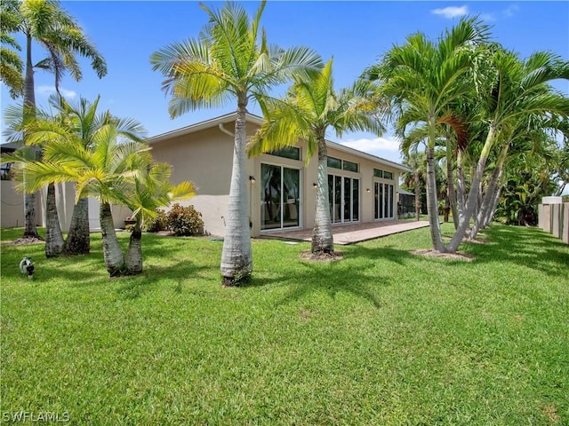 rear view of house featuring a yard